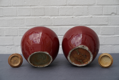 A pair of Chinese monochrome oxblood-glazed jars and covers, 19th C.